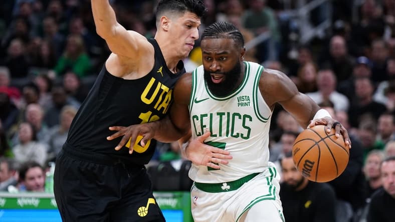 Jan 5, 2024; Boston, Massachusetts, USA; Boston Celtics guard Jaylen Brown (7) drives the ball against Utah Jazz forward Simone Fontecchio (16) in the second quarter at TD Garden. Mandatory Credit: David Butler II-USA TODAY Sports