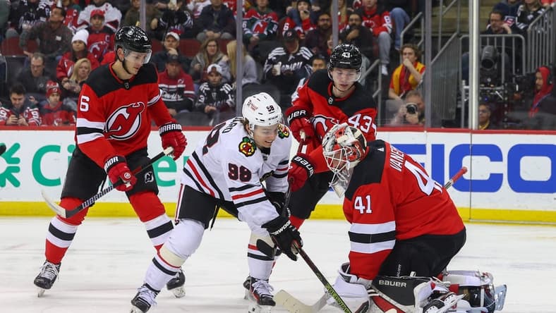 Jan 5, 2024; Newark, New Jersey, USA; New Jersey Devils goaltender Vitek Vanecek (41) makes a save while Chicago Blackhawks center Connor Bedard (98) looks for the rebound during the first period at Prudential Center. Mandatory Credit: Ed Mulholland-USA TODAY Sports