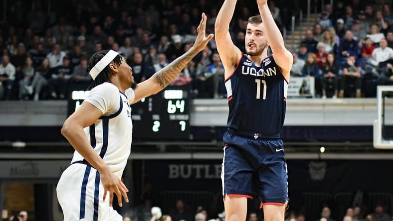 Jan 5, 2024; Indianapolis, Indiana, USA; Connecticut Huskies forward Alex Karaban (11) attempts a shot over Butler Bulldogs forward Jalen Thomas (1) during the second half at Hinkle Fieldhouse. Mandatory Credit: Robert Goddin-USA TODAY Sports