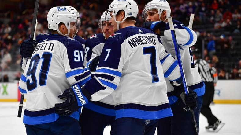 Jan 5, 2024; Anaheim, California, USA; Winnipeg Jets celebrate the goal scored by center Cole Perfetti (91) against the Anaheim Ducks during the third period at Honda Center. Mandatory Credit: Gary A. Vasquez-USA TODAY Sports