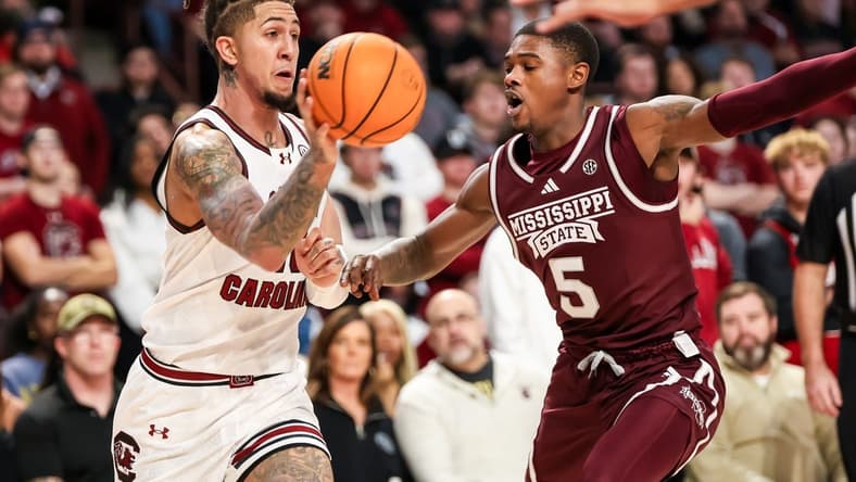 Jan 6, 2024; Columbia, South Carolina, USA; South Carolina Gamecocks guard Myles Stute (10) passes around Mississippi State Bulldogs guard Shawn Jones Jr. (5) in the first half at Colonial Life Arena. Mandatory Credit: Jeff Blake-USA TODAY Sports