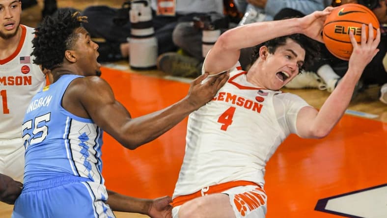 Jan 6, 2024; Clemson, South Carolina, USA; Clemson junior forward Ian Schieffelin (4) rebounds near University of North Carolina forward Harrison Ingram (55) during the first half at Littlejohn Coliseum. Mandatory Credit: Ken Ruinard-USA TODAY Sports