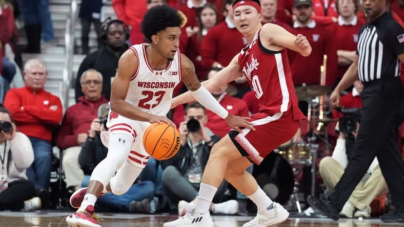 Jan 6, 2024; Madison, Wisconsin, USA; Wisconsin Badgers guard Chucky Hepburn (23) dribbles the ball against Nebraska Cornhuskers guard Keisei Tominaga (30) during the first half at the Kohl Center. Mandatory Credit: Kayla Wolf-USA TODAY Sports