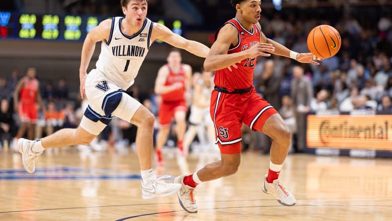 Jan 6, 2024; Villanova, Pennsylvania, USA; St. John's Red Storm guard RJ Luis Jr. (12) picks up the loose ball past Villanova Wildcats guard Brendan Hausen (1) during the second half at William B. Finneran Pavilion. Mandatory Credit: Bill Streicher-USA TODAY Sports