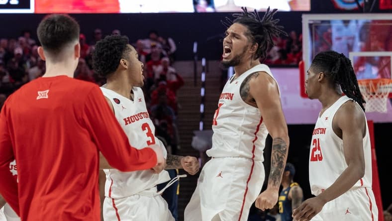 Jan 6, 2024; Houston, Texas, USA;Houston Cougars guard Emanuel Sharp (21) celebrates with guard Ramon Walker Jr. (3) against the West Virginia Mountaineers  in the first half  at Fertitta Center. Mandatory Credit: Thomas Shea-USA TODAY Sports