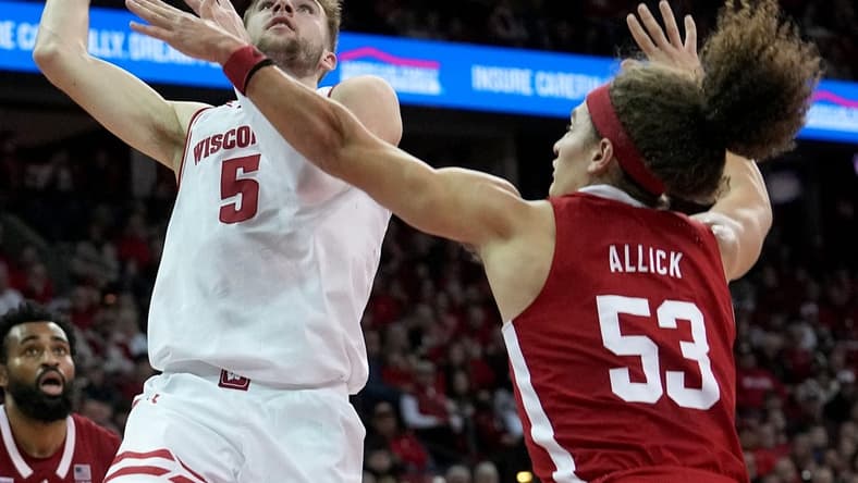Jan 6, 2024; Madison, Wisconsin, USA; Wisconsin forward Tyler Wahl (5) scores on Nebraska forward Josiah Allick (53) during the second half at Kohl Center. Mandatory Credit: Mark Hoffman-USA TODAY Sports