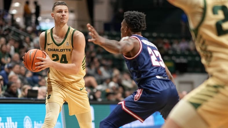 Jan 6, 2024; Charlotte, North Carolina, USA; Charlotte 49ers forward Igor Milicic Jr. (24) looks to pass around Florida Atlantic Owls guard Brandon Weatherspoon (23) during the first half at Dale F. Halton Arena. Mandatory Credit: Jim Dedmon-USA TODAY Sports