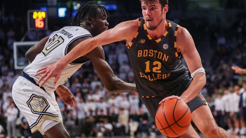 Jan 6, 2024; Atlanta, Georgia, USA; Boston College Eagles forward Quinten Post (12) drives on Georgia Tech Yellow Jackets forward Ebenezer Dowuona (10) in the first half at McCamish Pavilion. Mandatory Credit: Brett Davis-USA TODAY Sports