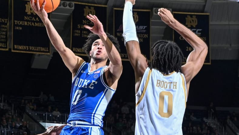 Jan 6, 2024; South Bend, Indiana, USA; Duke Blue Devils guard Jared McCain (0) goes up for a shot as Notre Dame Fighting Irish forward Carey Booth (0) defends in the second half at the Purcell Pavilion. Mandatory Credit: Matt Cashore-USA TODAY Sports