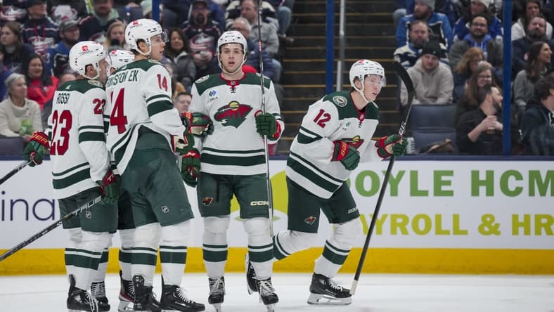 Jan 6, 2024; Columbus, Ohio, USA;  Minnesota Wild left wing Matt Boldy (12) celebrates with teammates after scoring a goal against the Columbus Blue Jackets in the second period at Nationwide Arena. Mandatory Credit: Aaron Doster-USA TODAY Sports