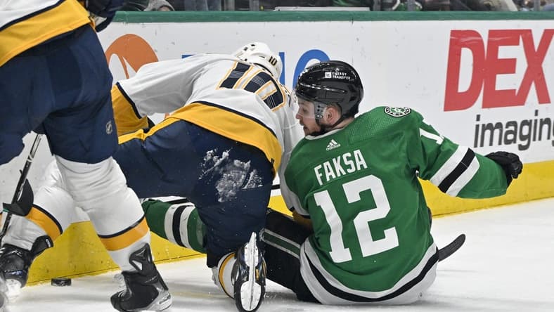 Jan 6, 2024; Dallas, Texas, USA; Nashville Predators center Colton Sissons (10) and Dallas Stars center Radek Faksa (12) battle for control of the puck along the boards during the second period at the American Airlines Center. Mandatory Credit: Jerome Miron-USA TODAY Sports