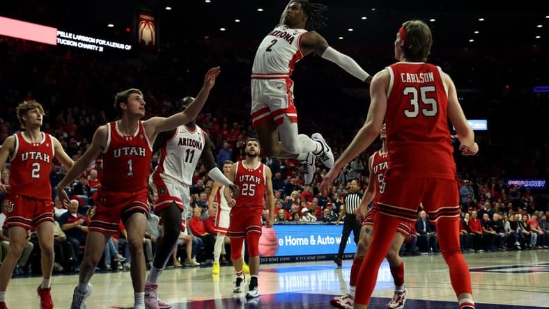 Jan 6, 2024; Tucson, Arizona, USA; Arizona Wildcats guard Caleb Love (2) makes a basket against Utah Utes forward Ben Carlson (1) during the second half at McKale Center. Mandatory Credit: Zachary BonDurant-USA TODAY Sports