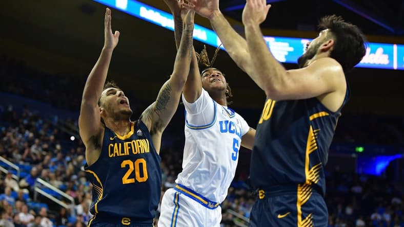 Jan 6, 2024; Los Angeles, California, USA; UCLA Bruins guard Brandon Williams (5) plays for the rebound against California Golden Bears guard Jaylon Tyson (20) and forward Fardaws Aimaq (00) during the first half at Pauley Pavilion. Mandatory Credit: Gary A. Vasquez-USA TODAY Sports