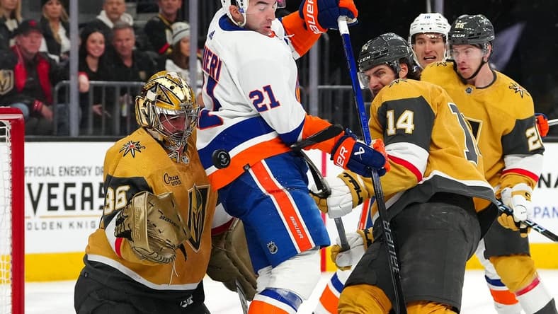 Jan 6, 2024; Las Vegas, Nevada, USA; A shot deflects off New York Islanders center Kyle Palmieri (21) between Vegas Golden Knights goaltender Logan Thompson (36) and Vegas Golden Knights defenseman Nicolas Hague (14) during the first period at T-Mobile Arena. Mandatory Credit: Stephen R. Sylvanie-USA TODAY Sports
