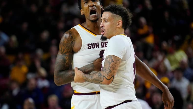 Jan. 6, 2024; Phoenix, Ariz; USA; ASU guard Jose Perez (12) holds back center Shawn Phillips Jr. (9) from arguing with an official during a game against Colorado at Desert Financial Arena.