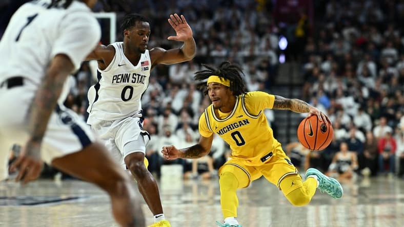 Jan 7, 2024; Philadelphia, Pennsylvania, USA; Michigan Wolverines guard Dug McDaniel (0) drives against Penn State Nittany Lions guard Kanye Clary (0) in the second half at The Palestra. Mandatory Credit: Kyle Ross-USA TODAY Sports