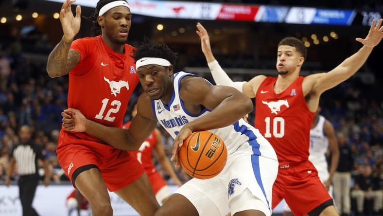 Jan 7, 2024; Memphis, Tennessee, USA; Memphis Tigers forward Malcolm Dandridge (23) dribbles as Southern Methodist Mustangs forward Tyreek Smith (12) and forward Samuell Williamson (10) defend during the first half at FedExForum. Mandatory Credit: Petre Thomas-USA TODAY Sports