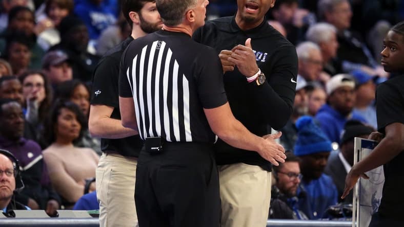 Jan 7, 2024; Memphis, Tennessee, USA; Memphis Tigers head coach Penny Hardaway (right) is held back by an official during the first half against the Southern Methodist Mustangs at FedExForum. Mandatory Credit: Petre Thomas-USA TODAY Sports