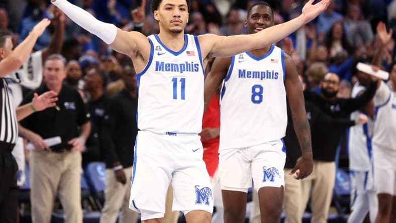 Jan 7, 2024; Memphis, Tennessee, USA; Memphis Tigers guard Jahvon Quinerly (11) reacts after making a three point shot with 3.2 seconds left during the second half against the Southern Methodist Mustangs at FedExForum. Mandatory Credit: Petre Thomas-USA TODAY Sports