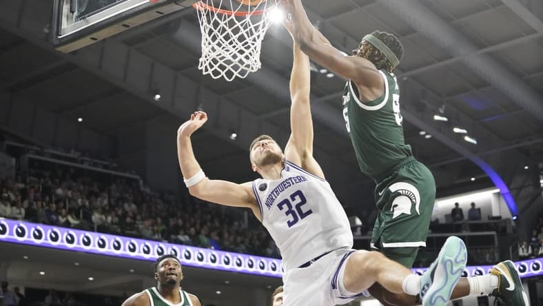 Jan 7, 2024; Evanston, Illinois, USA; Michigan State Spartans forward Coen Carr (55) goes up for a dunk on Northwestern Wildcats forward Blake Preston (32) during the first half at Welsh-Ryan Arena. Mandatory Credit: David Banks-USA TODAY Sports