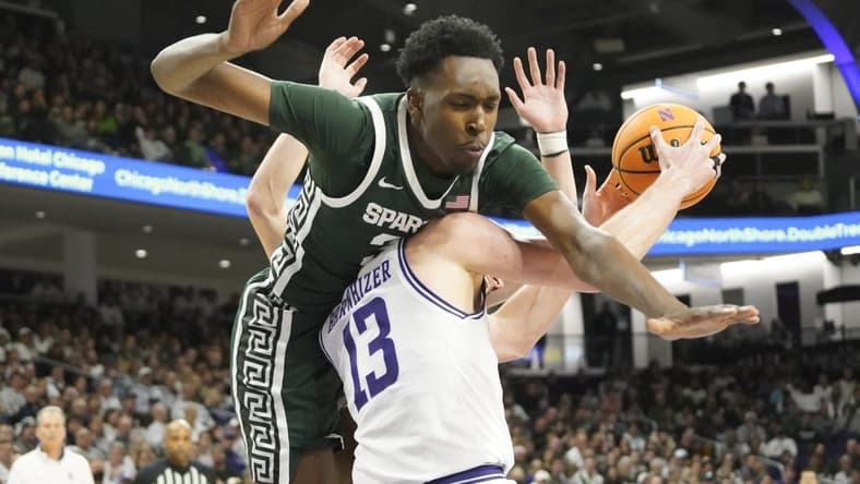 Jan 7, 2024; Evanston, Illinois, USA; Michigan State Spartans forward Xavier Booker (34) defends Northwestern Wildcats guard Brooks Barnhizer (13) during the second half at Welsh-Ryan Arena. Mandatory Credit: David Banks-USA TODAY Sports