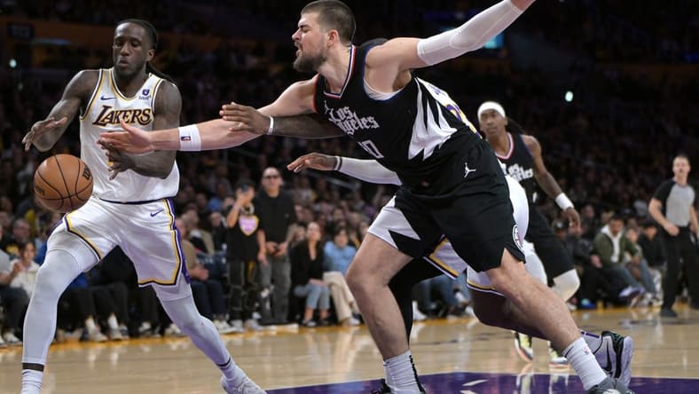 Jan 7, 2024; Los Angeles, California, USA; Los Angeles Lakers forward Taurean Prince (12) and Los Angeles Clippers center Ivica Zubac (40) reach for a rebound in the second half at Crypto.com Arena. Mandatory Credit: Jayne Kamin-Oncea-USA TODAY Sports