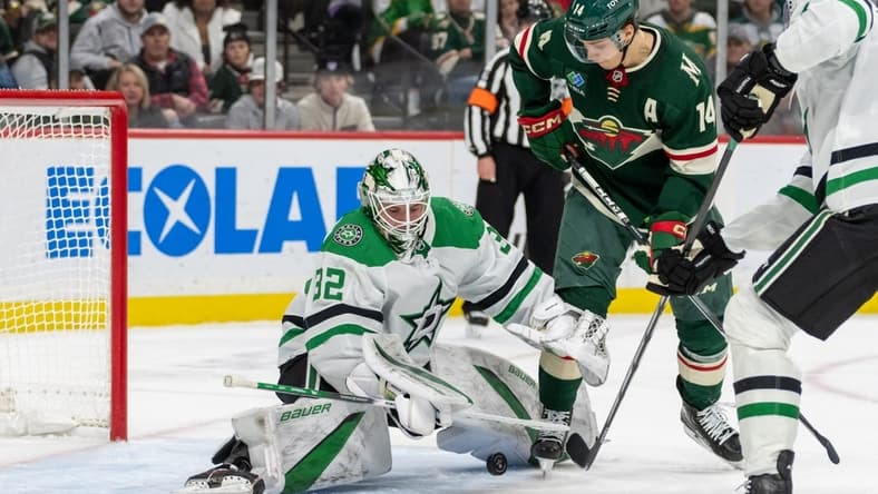 Jan 8, 2024; Saint Paul, Minnesota, USA; Dallas Stars goaltender Matt Murray (32) makes a save on Minnesota Wild center Joel Eriksson Ek (14) in the second period at Xcel Energy Center. Mandatory Credit: Matt Blewett-USA TODAY Sports