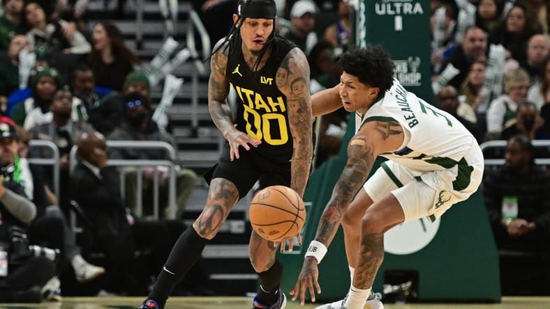 Jan 8, 2024; Milwaukee, Wisconsin, USA; Utah Jazz guard Jordan Clarkson (00) and Milwaukee Bucks guard MarJon Beauchamp (3) reach for a loose ball in the third quarter at Fiserv Forum. Mandatory Credit: Benny Sieu-USA TODAY Sports