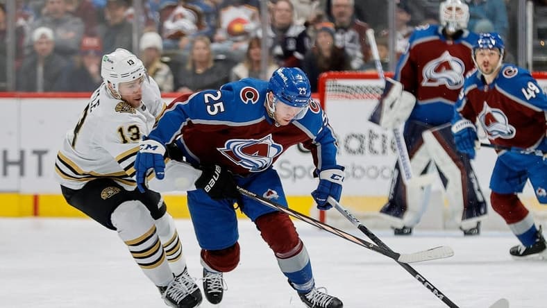 Jan 8, 2024; Denver, Colorado, USA; Colorado Avalanche right wing Logan O'Connor (25) and Boston Bruins center Charlie Coyle (13) battle for the puck in the second period at Ball Arena. Mandatory Credit: Isaiah J. Downing-USA TODAY Sports