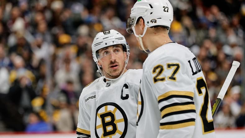 Jan 8, 2024; Denver, Colorado, USA; Boston Bruins left wing Brad Marchand (63) and defenseman Hampus Lindholm (27) in the second period against the Colorado Avalanche at Ball Arena. Mandatory Credit: Isaiah J. Downing-USA TODAY Sports