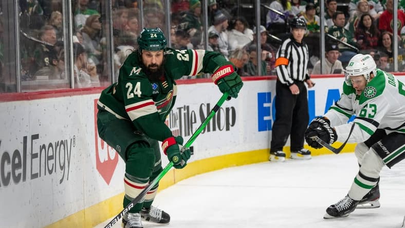 Jan 8, 2024; Saint Paul, Minnesota, USA; Minnesota Wild defenseman Zach Bogosian (24) clears the puck, pressed by Dallas Stars right wing Evgenii Dadonov (63) in the third period at Xcel Energy Center. Mandatory Credit: Matt Blewett-USA TODAY Sports