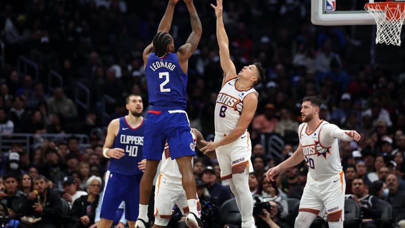Jan 8, 2024; Los Angeles, California, USA; Los Angeles Clippers forward Kawhi Leonard (2) shoots the ball over Phoenix Suns guard Grayson Allen (8) during the second half at Crypto.com Arena. Mandatory Credit: Kiyoshi Mio-USA TODAY Sports