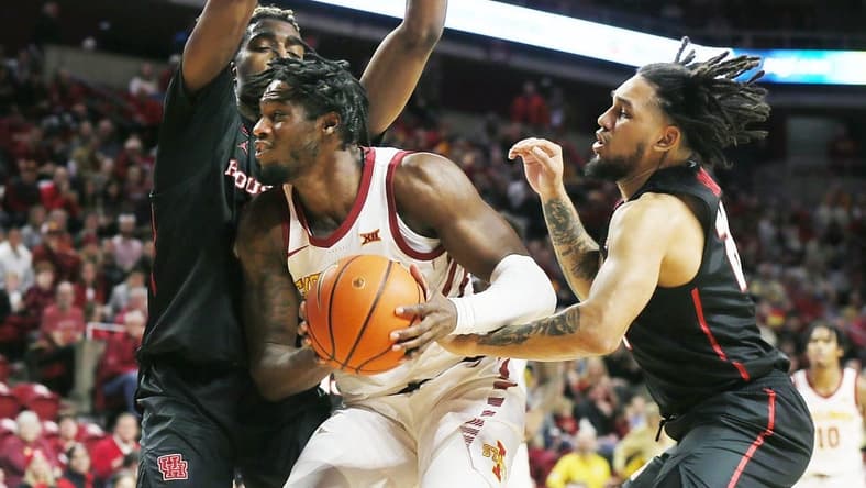 Iowa State Cyclones forward Tre King (0) drives to the basket a between Houston Cougars forward Ja'Vier Francis (5) and guard Emanuel Sharp (21) during the first half in the Big-12 conference showdown of an NCAA college basketball at Hilton Coliseum on Tuesday, Jan. 9, 2024, in Ames, Iowa.