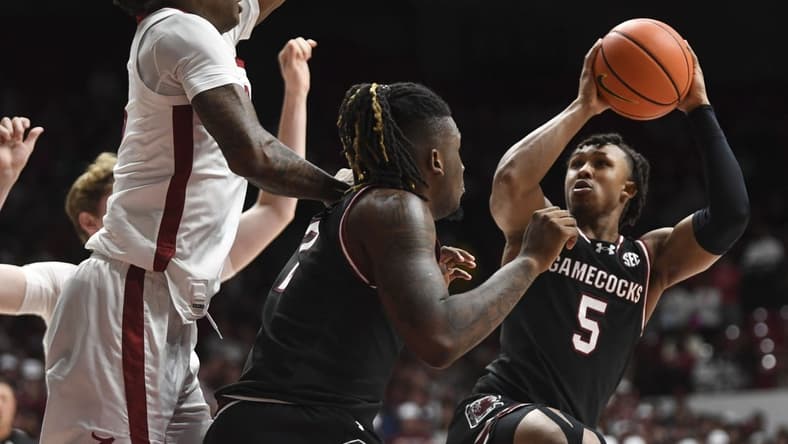 Jan 9, 2024; Tuscaloosa, Alabama, USA; South Carolina guard Meechie Johnson (5) shoots the ball defended by Alabama forward Nick Pringle (23) during the game Coleman Coliseum. Mandatory Credit: Gary Cosby Jr.-USA TODAY Sports