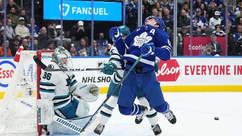 Jan 9, 2024; Toronto, Ontario, CAN; Toronto Maple Leafs right wing Mitchell Marner (16) battles for the puck in front of San Jose Sharks goaltender Kaapo Kahkonen (36) during the first period at Scotiabank Arena. Mandatory Credit: Nick Turchiaro-USA TODAY Sports