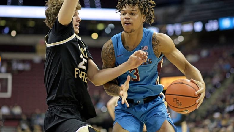 Jan 9, 2024; Tallahassee, Florida, USA; Wake Forest Demon Deacons forward Zach Keller (25) defends a drive by Florida State Seminoles guard Cam Corhen (3) during the first half at Donald L. Tucker Center. Mandatory Credit: Melina Myers-USA TODAY Sports