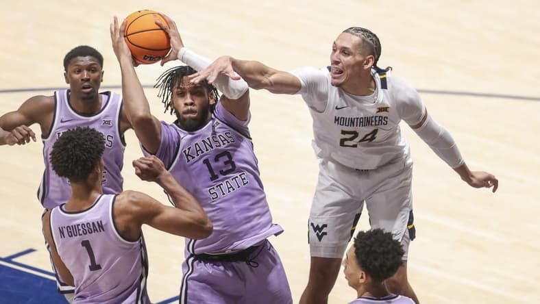 Jan 9, 2024; Morgantown, West Virginia, USA; Kansas State Wildcats forward Will McNair Jr. (13) grabs a rebound over West Virginia Mountaineers forward Patrick Suemnick (24) during the first half at WVU Coliseum. Mandatory Credit: Ben Queen-USA TODAY Sports