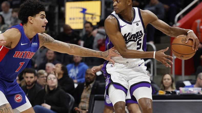 Jan 9, 2024; Detroit, Michigan, USA; Sacramento Kings guard De'Aaron Fox (5) dribbles defended by Detroit Pistons guard Killian Hayes (7) in the first half at Little Caesars Arena. Mandatory Credit: Rick Osentoski-USA TODAY Sports