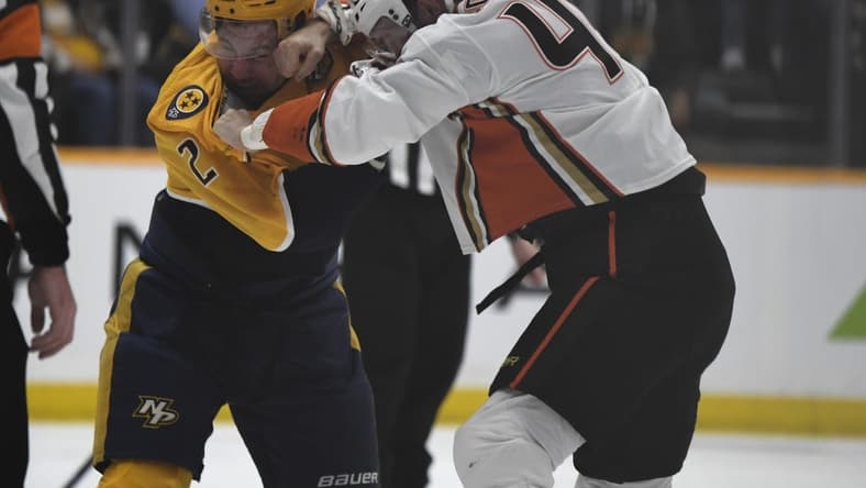 Jan 9, 2024; Nashville, Tennessee, USA; Nashville Predators defenseman Luke Schenn (2) and Anaheim Ducks left wing Ross Johnston (44) exchange punches doing a fight during the first period at Bridgestone Arena. Mandatory Credit: Christopher Hanewinckel-USA TODAY Sports