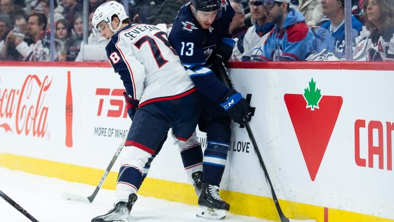 Jan 9, 2024; Winnipeg, Manitoba, CAN; Columbus Blue Jackets defenseman Damon Severson (78) boards Winnipeg Jets forward Gabriel Vilardi (13) during the second period at Canada Life Centre. Mandatory Credit: Terrence Lee-USA TODAY Sports