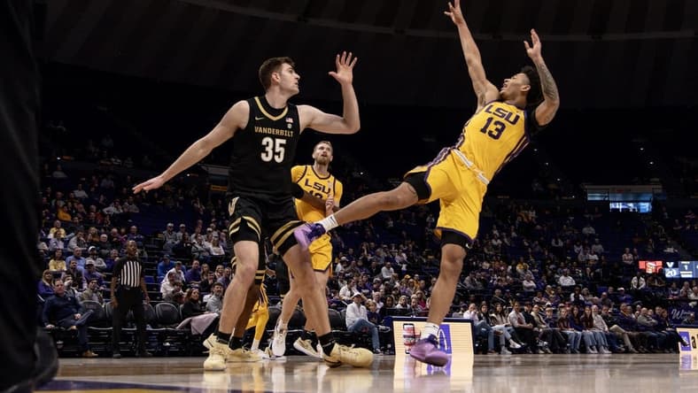 Jan 9, 2024; Baton Rouge, Louisiana, USA; LSU Tigers forward Jalen Reed (13) shoots a jump shot against Vanderbilt Commodores forward Carter Lang (35) during the first half at Pete Maravich Assembly Center. Mandatory Credit: Stephen Lew-USA TODAY Sports