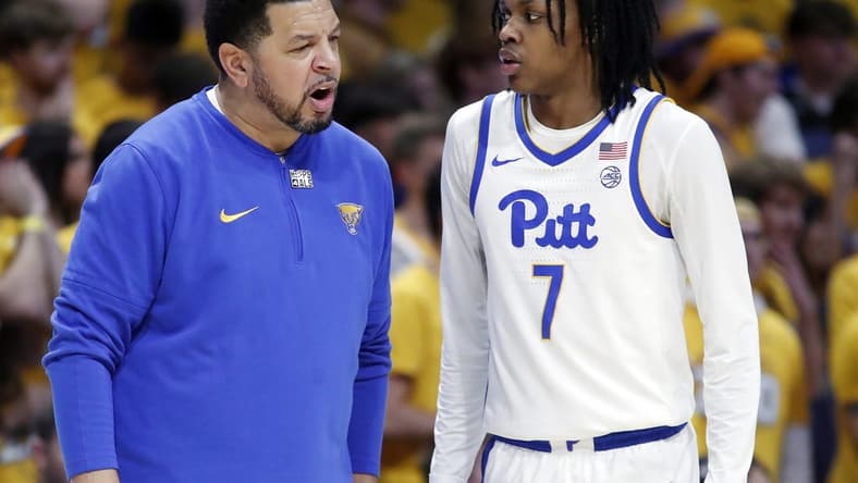 Jan 9, 2024; Pittsburgh, Pennsylvania, USA; Pittsburgh Panthers head coach Jeff Capel (left) talks with guard Carlton Carrington (7) against the Duke Blue Devils during the first half at the Petersen Events Center. Mandatory Credit: Charles LeClaire-USA TODAY Sports