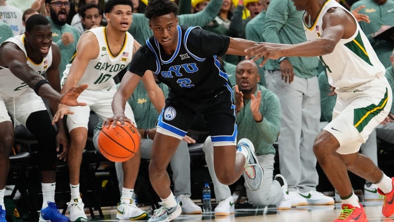 Jan 9, 2024; Waco, Texas, USA; Brigham Young Cougars guard Jaxson Robinson (2) controls the ball against Baylor Bears guard Ja'Kobe Walter (4) during the first half at Paul and Alejandra Foster Pavilion. Mandatory Credit: Chris Jones-USA TODAY Sports