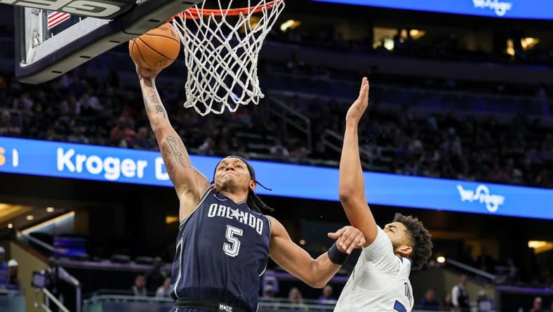 Jan 9, 2024; Orlando, Florida, USA; Orlando Magic forward Paolo Banchero (5) dunks against Minnesota Timberwolves center Karl-Anthony Towns (32) during the second half at KIA Center. Mandatory Credit: Mike Watters-USA TODAY Sports