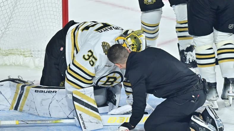 Jan 9, 2024; Tempe, Arizona, USA; Boston Bruins goaltender Linus Ullmark (35) is checked by an athletic trainer during overtime against the Arizona Coyotes at Mullett Arena. Mandatory Credit: Matt Kartozian-USA TODAY Sports