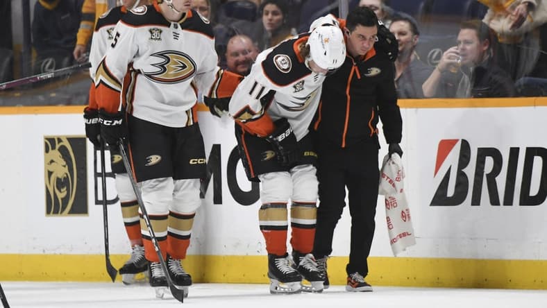 Jan 9, 2024; Nashville, Tennessee, USA; Anaheim Ducks center Trevor Zegras (11) is helped off the ice after an injury first period against the Nashville Predators at Bridgestone Arena. Mandatory Credit: Christopher Hanewinckel-USA TODAY Sports
