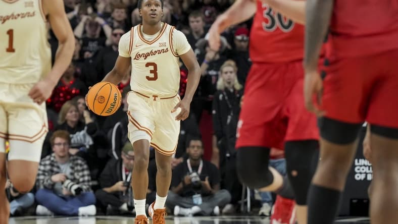 Jan 9, 2024; Cincinnati, Ohio, USA;  Texas Longhorns guard Max Abmas (3) dribbles the ball against the Cincinnati Bearcats in the second half at Fifth Third Arena. Mandatory Credit: Aaron Doster-USA TODAY Sports
