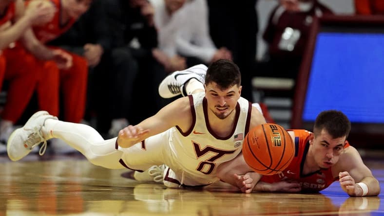 Jan 10, 2024; Blacksburg, Virginia, USA; Virginia Tech Hokies guard Hunter Cattoor (0) and Clemson Tigers guard Joseph Girard III (11) go for the ball during the first half at Cassell Coliseum. Mandatory Credit: Peter Casey-USA TODAY Sports