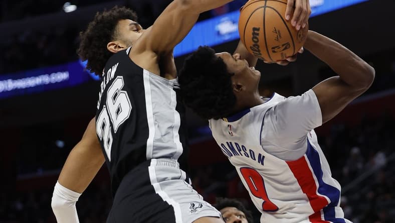 Jan 10, 2024; Detroit, Michigan, USA; San Antonio Spurs forward Dominick Barlow (26) blocks a shot by Detroit Pistons forward Ausar Thompson (9) in the first half at Little Caesars Arena. Mandatory Credit: Rick Osentoski-USA TODAY Sports
