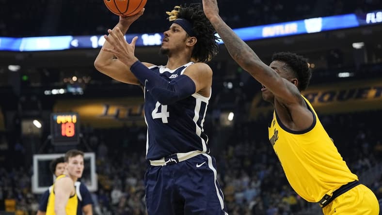 Jan 10, 2024; Milwaukee, Wisconsin, USA; Butler Bulldogs guard DJ Davis (4) shoots in front of Marquette Golden Eagles guard Kam Jones (1) during the first half at Fiserv Forum. Mandatory Credit: Jeff Hanisch-USA TODAY Sports
